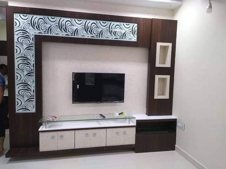 Living-room TV unit with patterned panels, display niches and white base storage