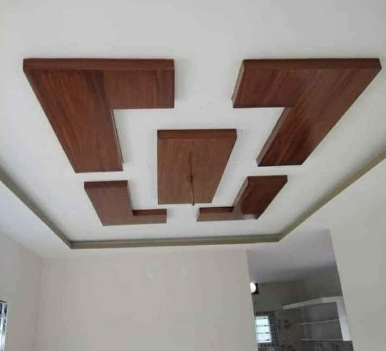 False ceiling with layered wood-finish panels on a white POP ceiling
